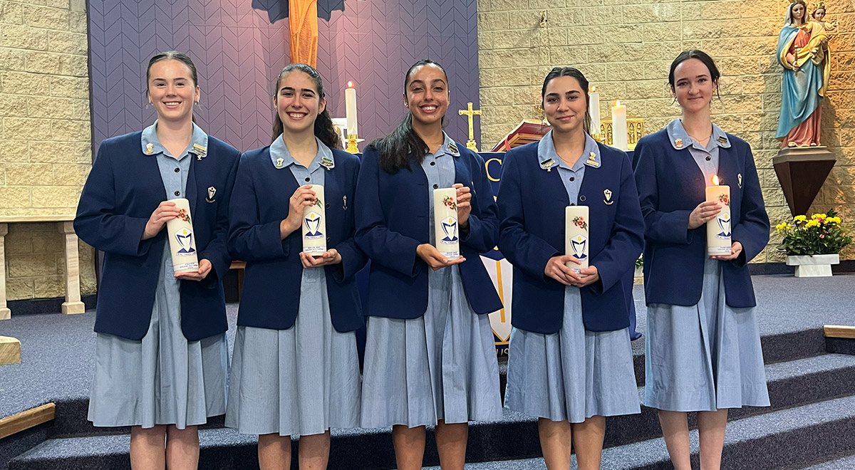 Girls holding candles at Cerdon College Merrylands