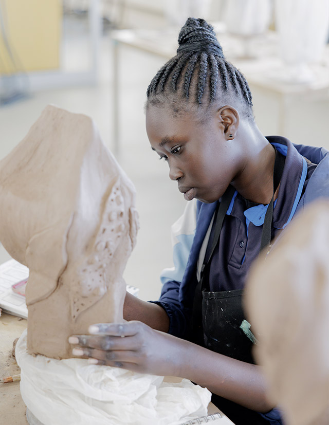Cerdon Catholic College Merrylands student creating sculpture with clay