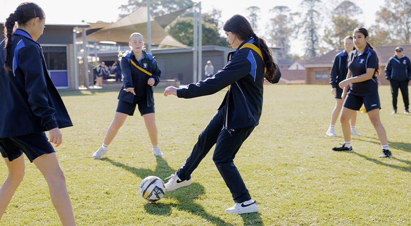 Cerdon Catholic College Merrylands students playing soccer in school field