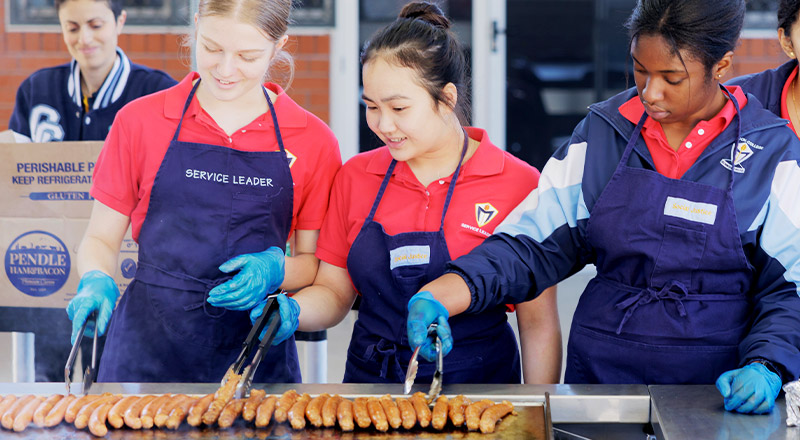 Student using external BBQ on Cerdon College Merrylands campus
