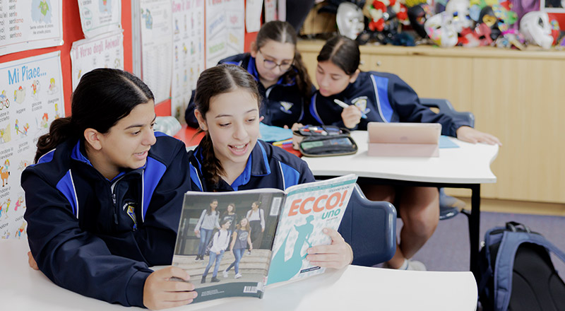 Students learning Italian from textbook at Cerdon College Merrylands
