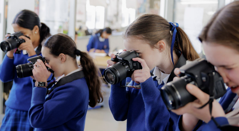 Students using cameras at Cerdon College Merrylands