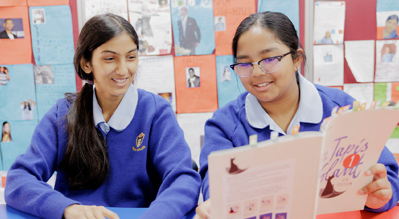 Students reading book inside Cerdon College Merrylands classroom