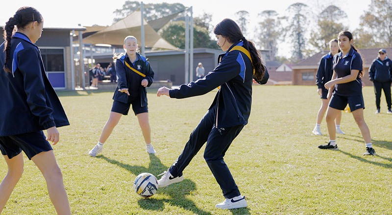 Students playing soccer on Cerdon College Merrylands sports field