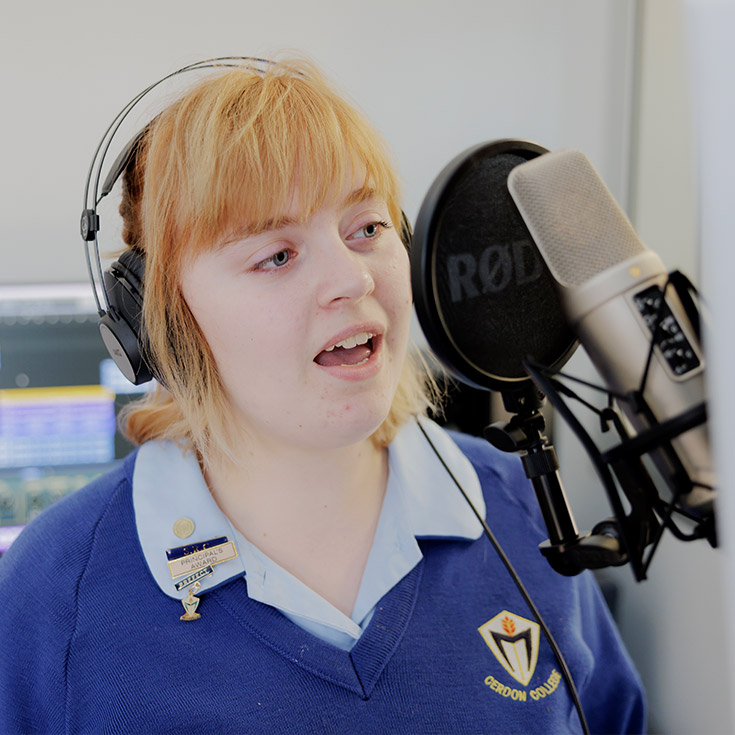 Student inside audio booth at Cerdon College Merrylands