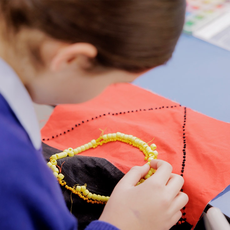 Student from Cerdon College Merrylands practicing sewing skills