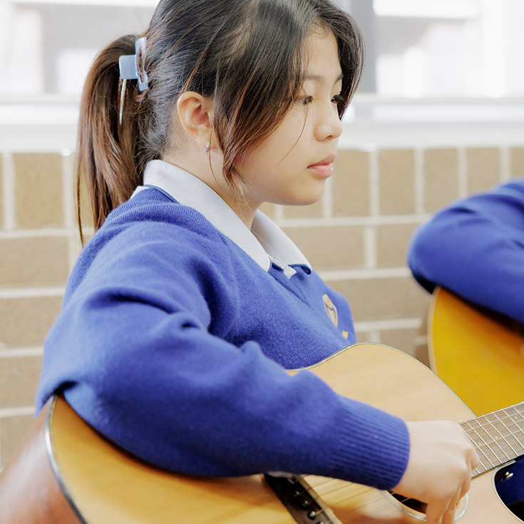 Cerdon Catholic College Merrylands student playing the guitar