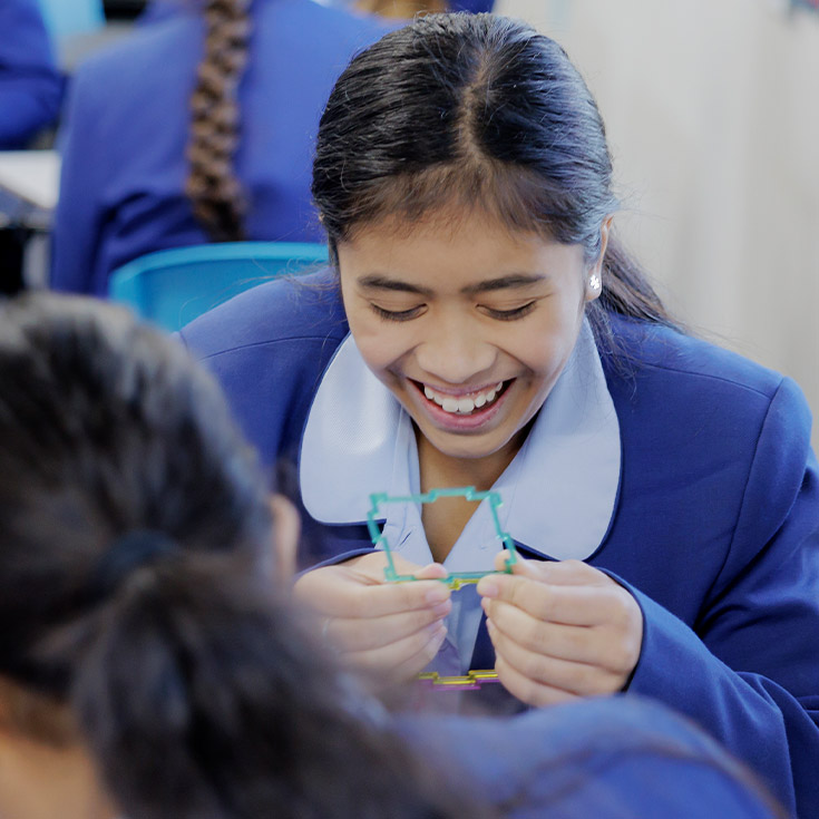 Student grinning while learning at Cerdon College Merrylands